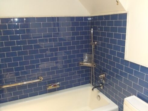 Blue subway tile in bathroom installed with JLQ Construction in California