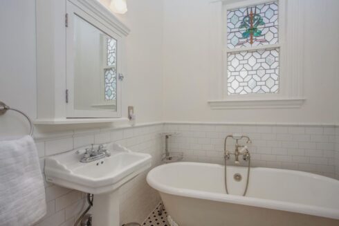 Cute, white bathroom redesign with JLQ Construction
