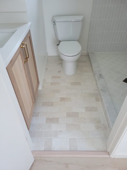 White floor tile in bathroom installed