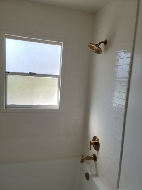 white subway tile with gold fixtures in California home